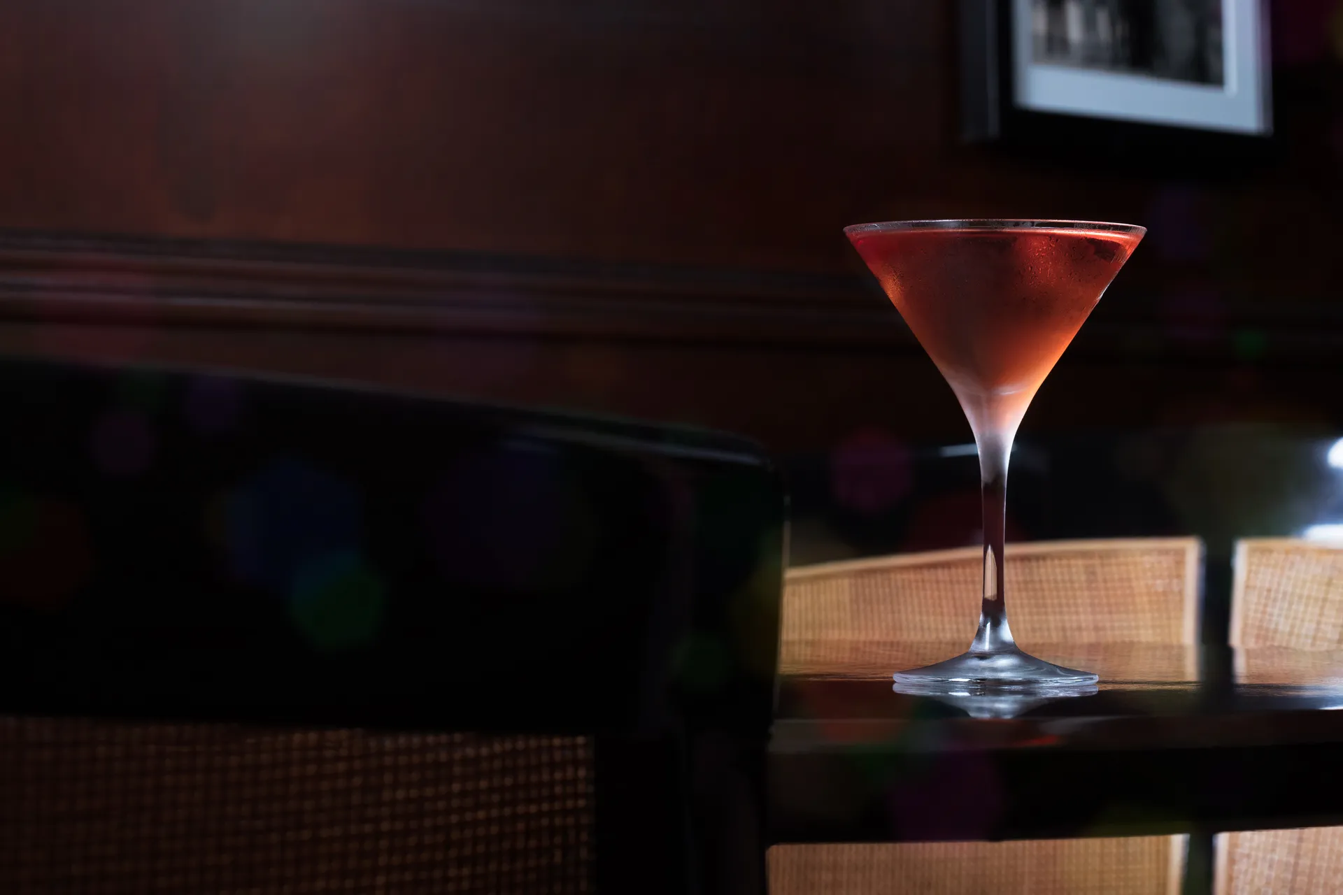 A Brigadier cocktail in a martini glass on the dark wood bar at BlackTail, New York.