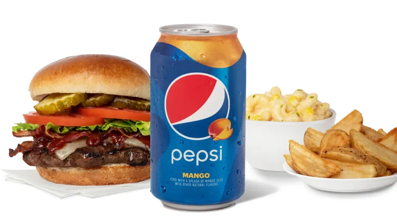 Pepsi Mango can with a burger, macaroni, and potato wedges, product group on white