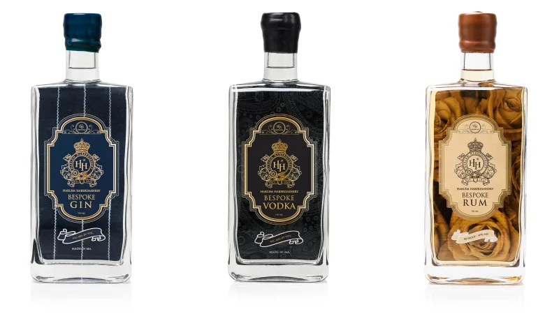 HH Bespoke gin, vodka and rum bottles in a row on white, each with a crested label.